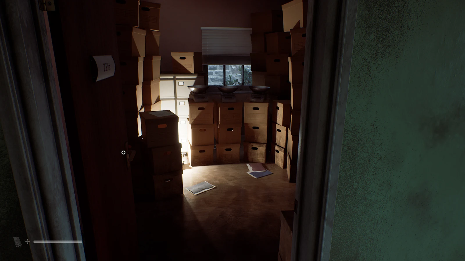 Проход в комнату с коробками, столом и экранами на дальней стене в Silent Hill: Townfall